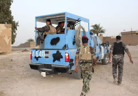 Members of the Iraqi security forces guard to secure an area from militants of the Islamic State, formerly known as the Islamic State in Iraq and the Levant (ISIL), in the Hamrin mountains in Diyala province July 25, 2014. REUTERS/Stringer