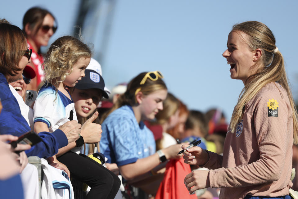 England's goalkeeper Hannah Hampton, right, reacts with fans at Central Coast Stadium in Gosford, Australia, Tuesday, July 25, 2023. England ranks second only to the United States in Women's World Cup ticket sales for countries outside of Australia and New Zealand. (AP Photo/Jessica Gratigny)