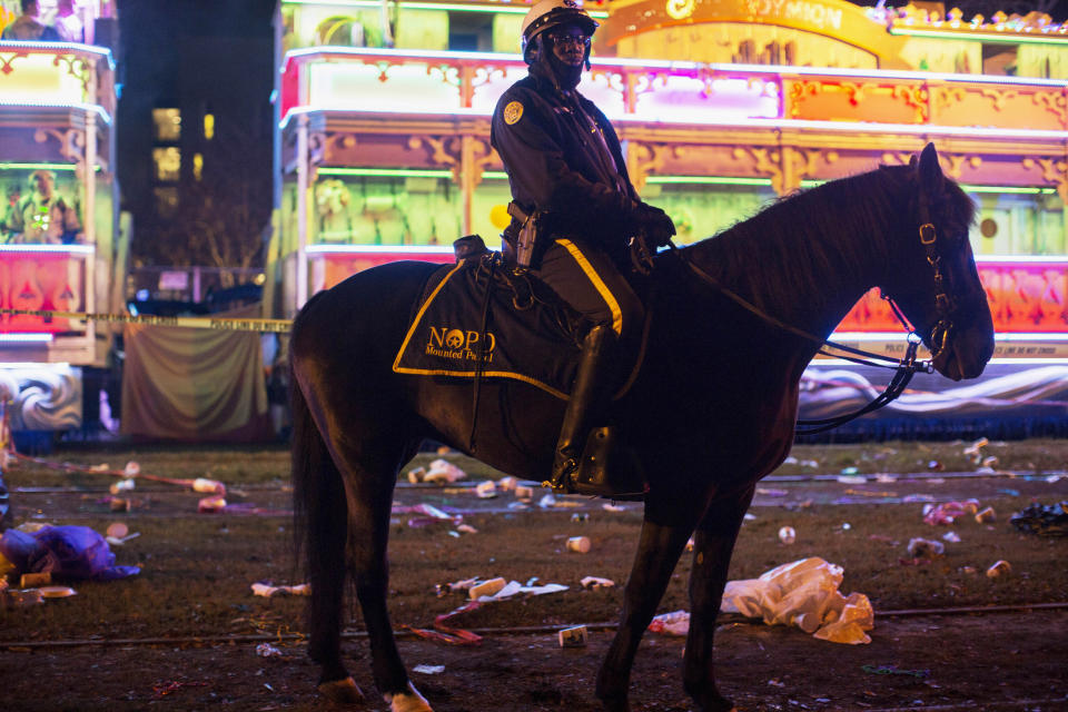 A police officer works the scene where a man was reportedly hit and killed by a float of the Krewe of Endymion parade in the runup to Mardi Gras in New Orleans, Saturday, Feb. 22, 2020. A person was struck by a float and fatally injured Saturday evening during one of the iconic parades of the Mardi Gras season in New Orleans, authorities said. It was the second death in days to mar this year's Carnival festivities. (Max Becherer/The Advocate via AP)