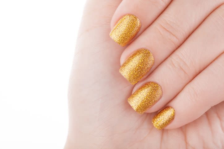 beautiful well groomed golden nails close up