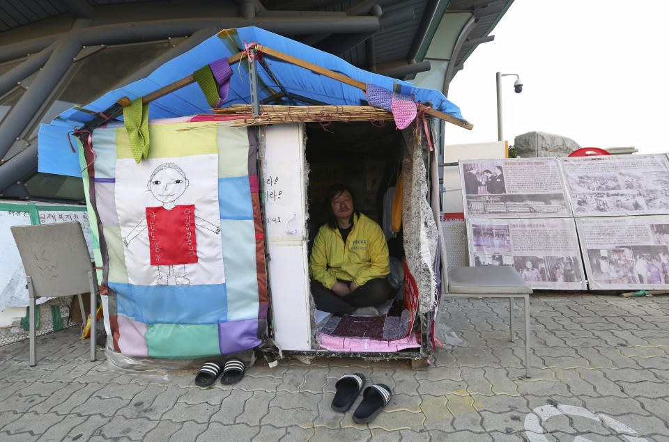 In this April 2, 2019, photo, Choi Seung-woo, a victim of Brothers Home, sits in a tent near the National Assembly in Seoul, South Korea. Choi and a small number of other Brothers Home inmates have been camping out in front of the National Assembly’s gate for more than two years calling for lawmakers to pass a bill that would launch a full investigation into past human rights atrocities, including the Brothers Home incident. (AP Photo/Ahn Young-joon)