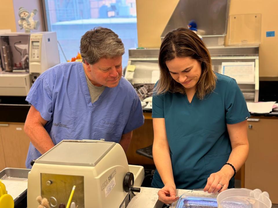 Dr. Bob Fraser, left, a pediatric pathologist at the IWK Health Centre in Halifax, is shown with medical laboratory technologist Erin Gillis on Dec. 6, 2023.