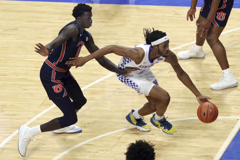 Kentucky's Isaiah Jackson, right, drives in front of Auburn's JT Thor during the second half of an NCAA college basketball game in Lexington, Ky., Saturday, Feb. 13, 2021. (AP Photo/James Crisp)