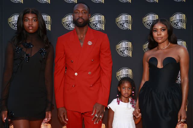 <p>Mike Lawrie/Getty </p> Dwyane Wade and Gabrielle Union with Kaavia and Zaya