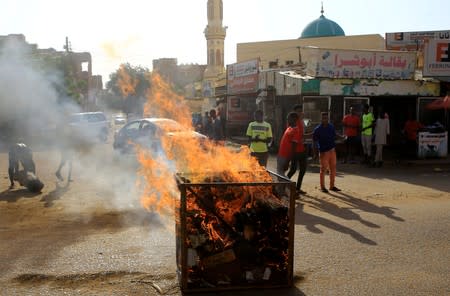 Protesters erect a fire barricade during a demonstration against a report of the Attorney-General on the dissolution of the sit-in protest in Khartoum