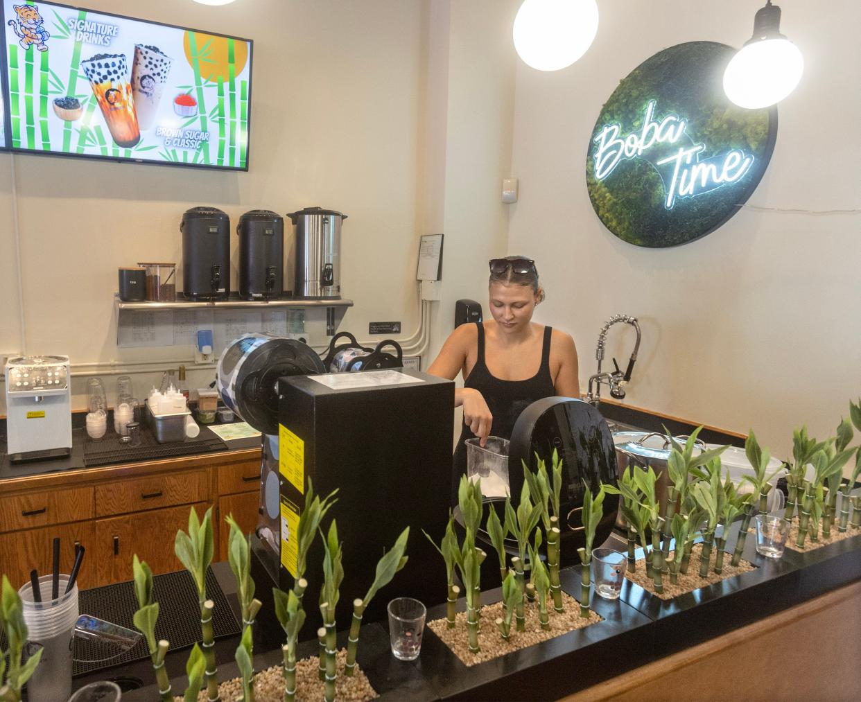 Mayci Sales makes a beverage at Golden Tiger Tea in downtown Massillon. Sales is working at the business with her brother, Maverick Sales, who is the tea shop owner.