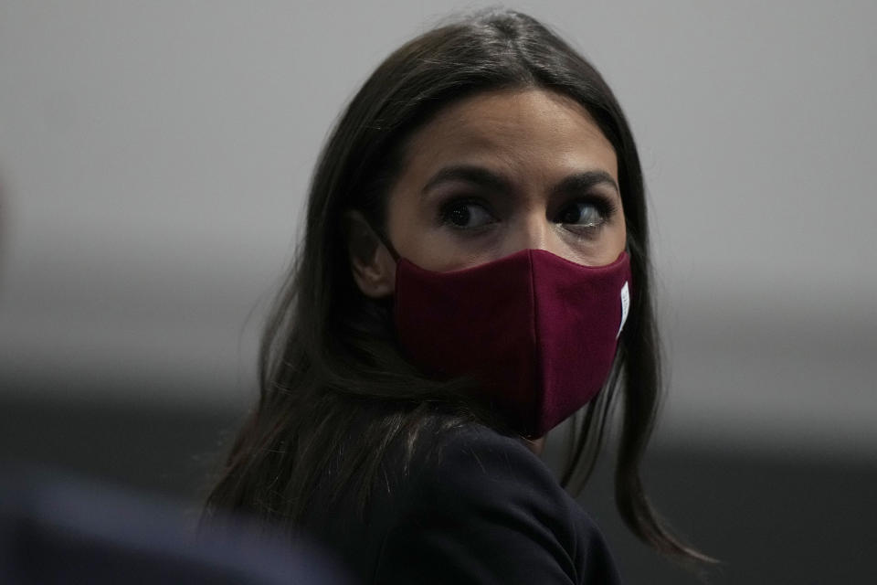 U.S. Rep. Alexandria Ocasio-Cortez looks round to listen to a question as she sits in the front row of the audience at an event in which the Speaker of the United States House of Representatives Nancy Pelosi was speaking, at the COP26 U.N. Climate Summit, in Glasgow, Scotland, Wednesday, Nov. 10, 2021. The U.N. climate summit in Glasgow has entered its second week as leaders from around the world, are gathering in Scotland's biggest city, to lay out their vision for addressing the common challenge of global warming. (AP Photo/Alastair Grant)