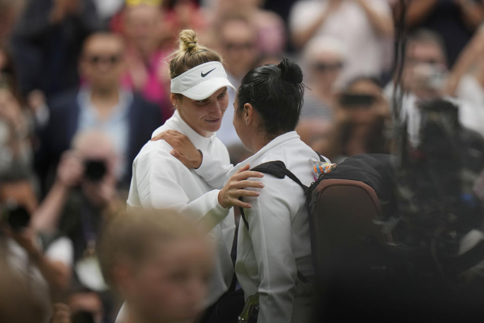 Czech Republic's Marketa Vondrousova, left, speaks with Tunisia's Ons Jabeur after beating her in the women's singles final on day thirteen of the Wimbledon tennis championships in London, Saturday, July 15, 2023. (AP Photo/Alastair Grant)