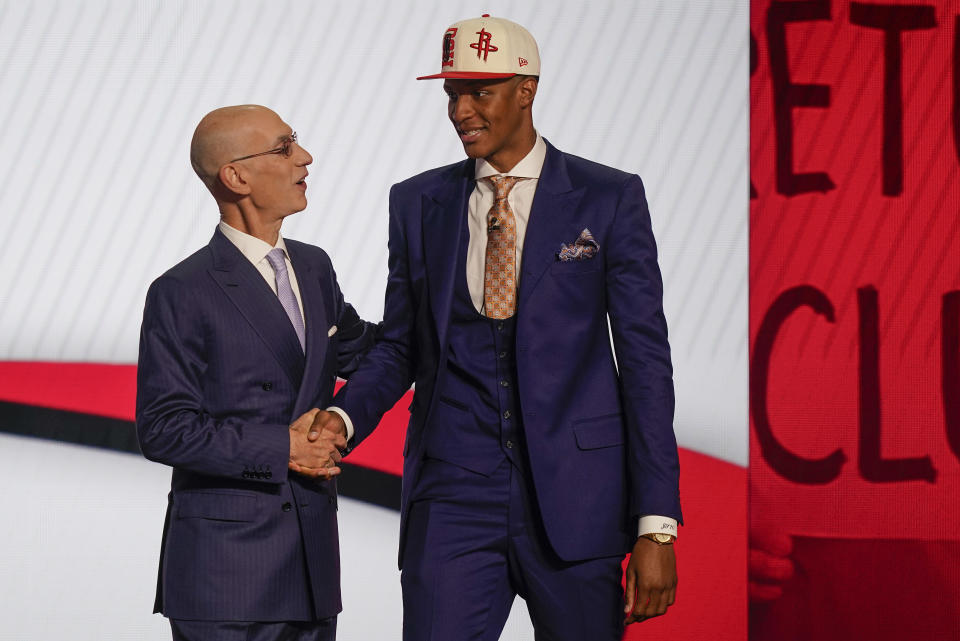 Jabari Smith Jr., right, is congratulated by NBA Commissioner Adam Silver after being selected third overall in the NBA basketball draft by the Houston Rockets, Thursday, June 23, 2022, in New York. (AP Photo/John Minchillo)