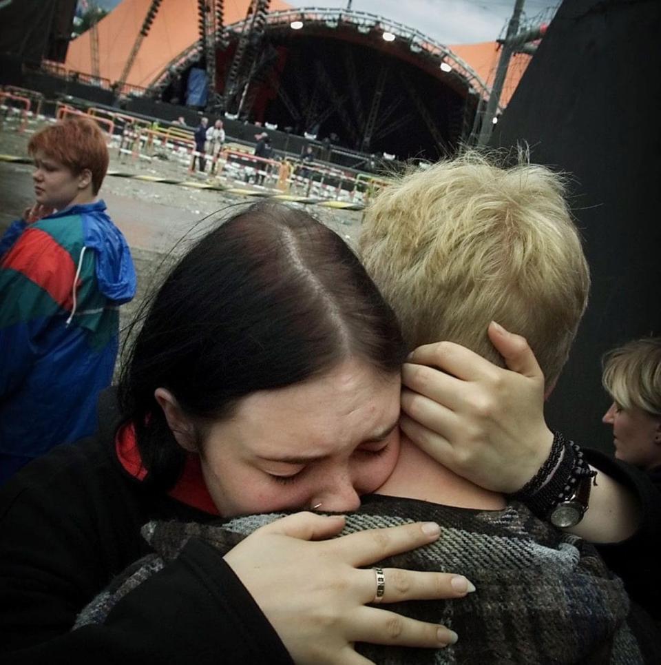 Fans consoling each other following Pearl Jam's concert in Denmark, 2000, at which people were crushed to death - AP