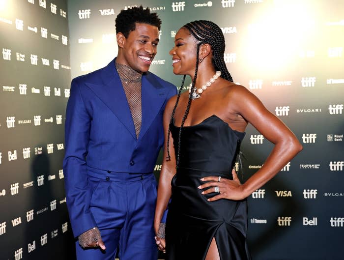 Jeremy and Gabrielle smiling at each other on the red carpet