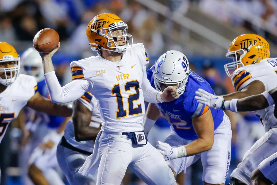 UTEP quarterback Gavin Hardison (12) looks for a receiver while coming under pressure from Boise State's Michael Callahan (92) during the first half of an NCAA college football game Friday, Sept. 10, 2021, in Boise, Idaho. (AP Photo/Steve Conner)
