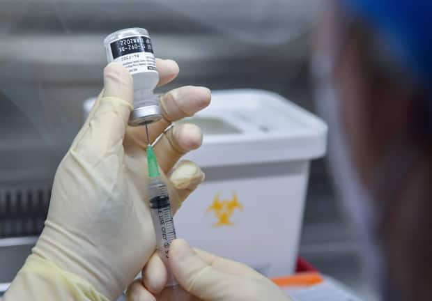 Dylan Murphy says he hopes there is room under Phase 2 of Newfoundland and Labrador's vaccine rollout plan for people who have chronic conditions but who have not been hospitalized in the last year. (Song Kyung-Seok/Pool Photo via AP - image credit)