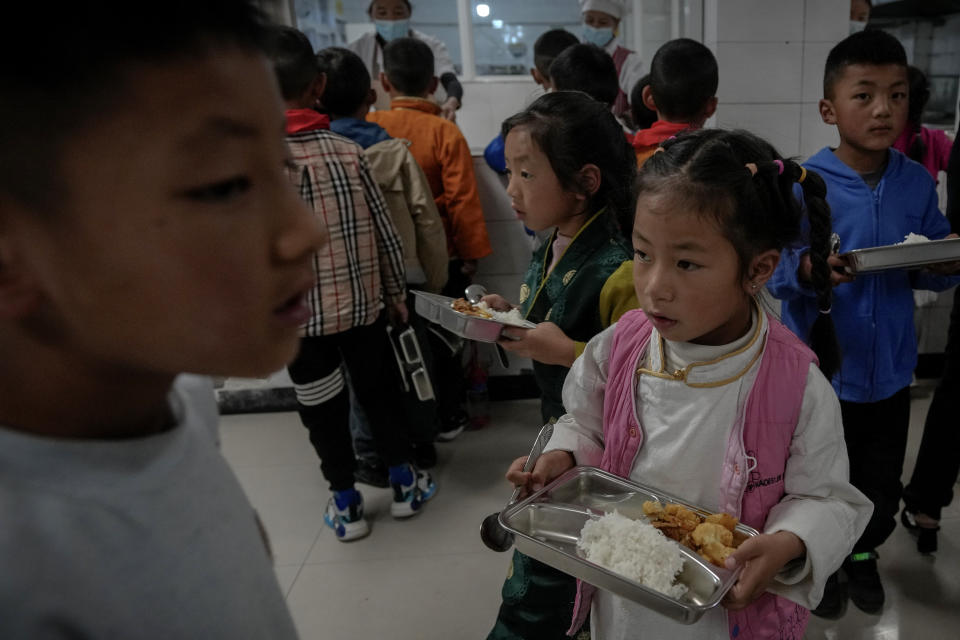 Tibetan students collect their meals at the Shangri-La Key Boarding School during a media-organized tour in Dabpa county, Kardze Prefecture, Sichuan province, China on Sept. 5, 2023. (AP Photo/Andy Wong)