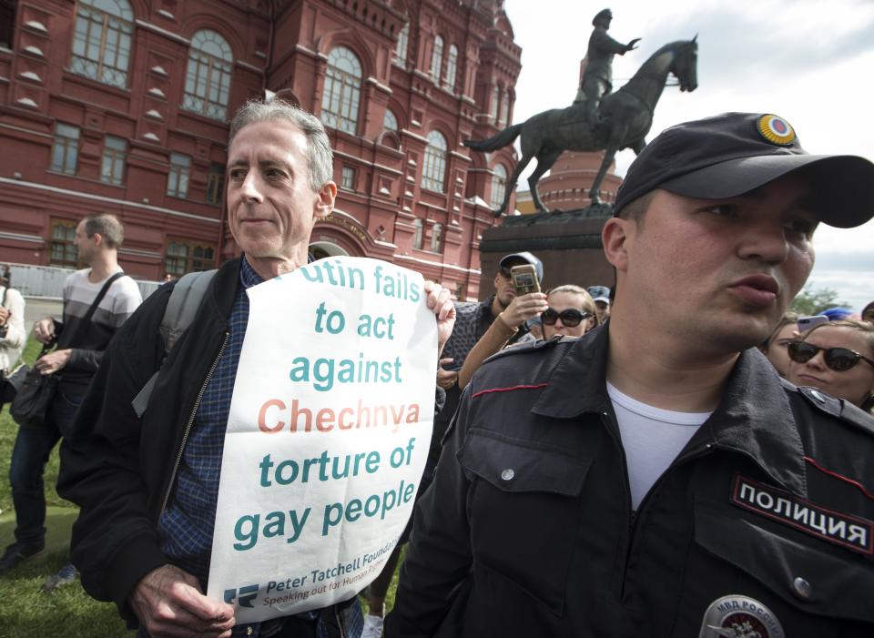 Russian police detain Gay rights activist Peter Tatchell, center, as he holds a banner that read “Putin fails to act against Chechnya torture of gay people” near Red Square in Moscow, Russia, Thursday, June 14, 2018. A British LGBT activist has been detained has been detained near the Red Square for holding a one-man protest against Russia’s abuse of gays. (AP Photo/Alexander Zemlianichenko)