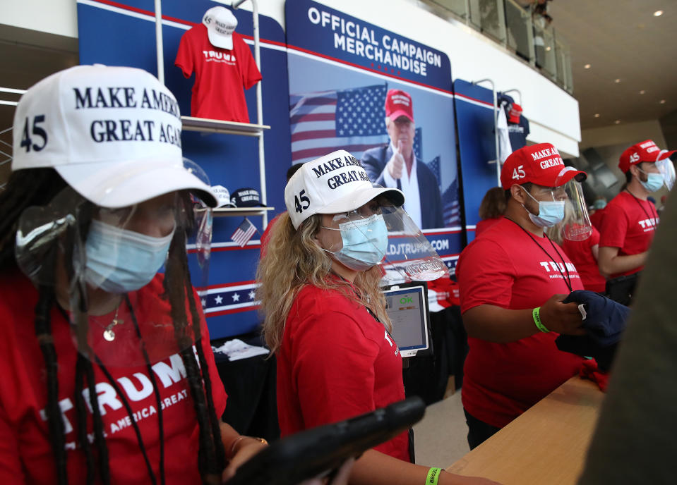 TULSA, OKLAHOMA - JUNE 20: Merchandise vendors wear masks while selling campaign gear during a rally for U.S. President Donald Trump at the BOK Center on June 20, 2020 in Tulsa, Oklahoma. Trump is holding his first political rally since the start of the coronavirus pandemic at the BOK Center on Saturday while infection rates in the state of Oklahoma continue to rise. (Photo by Win McNamee/Getty Images)