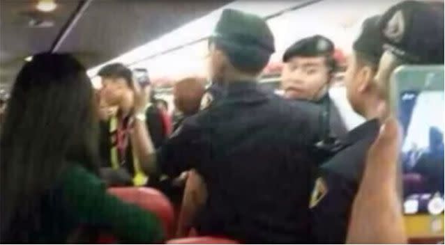 Passengers and crew observe an incident aboard a flight to China. Photo: YouTube