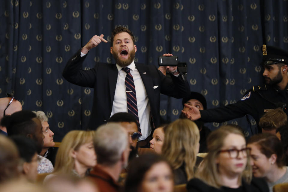 A protestor speaks out as the House Judiciary Committee hears investigative findings in the impeachment inquiry of President Donald Trump, Monday, Dec. 9, 2019, on Capitol Hill in Washington. (AP Photo/Andrew Harnik)