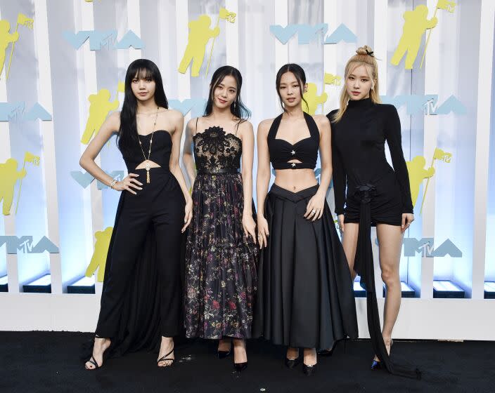 Lisa, Jisoo, Jennie, and Rosé of Blackpink in black formal wear posing for pictures at the MTV Video Music Awards