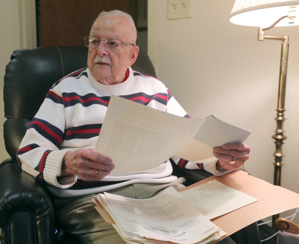 Former Barberton Mayor Kenneth Cox flips through a folder of letters of praise from his Republican counterparts throughout his career during a recent interview at his Pleasant View Assisted Living apartment in Barberton.
