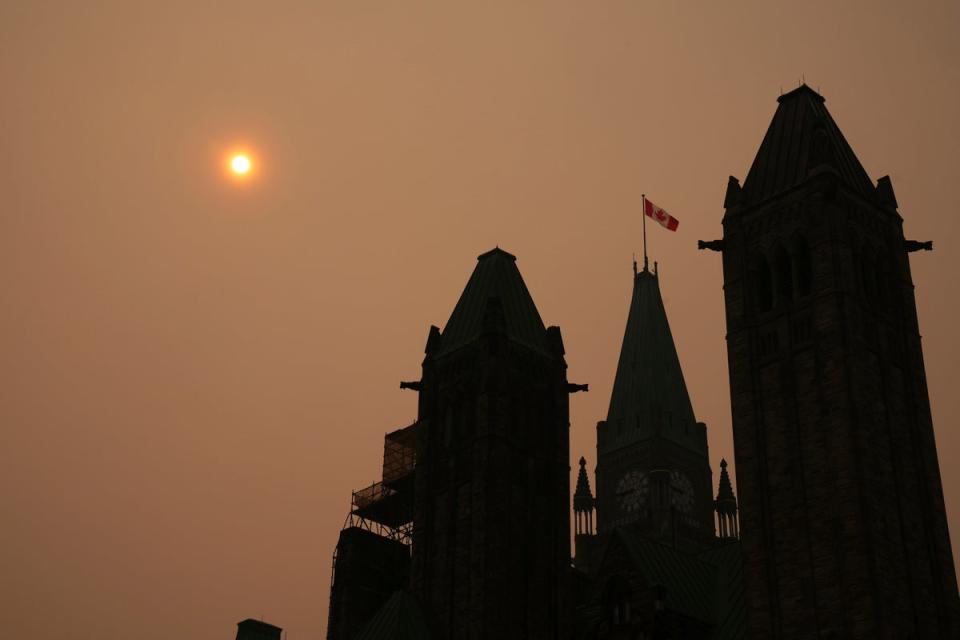 Smoke from wildfires in Ontario and Quebec is shown over Parliament Hill in Ottawa on Tuesday (AP)