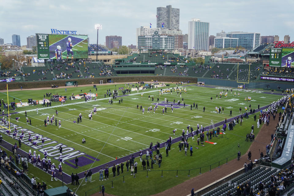 Iowa and Northwestern players warm up before an NCAA college football game Saturday, Nov. 4, 2023, at Wrigley Field in Chicago. (AP Photo/Erin Hooley)
