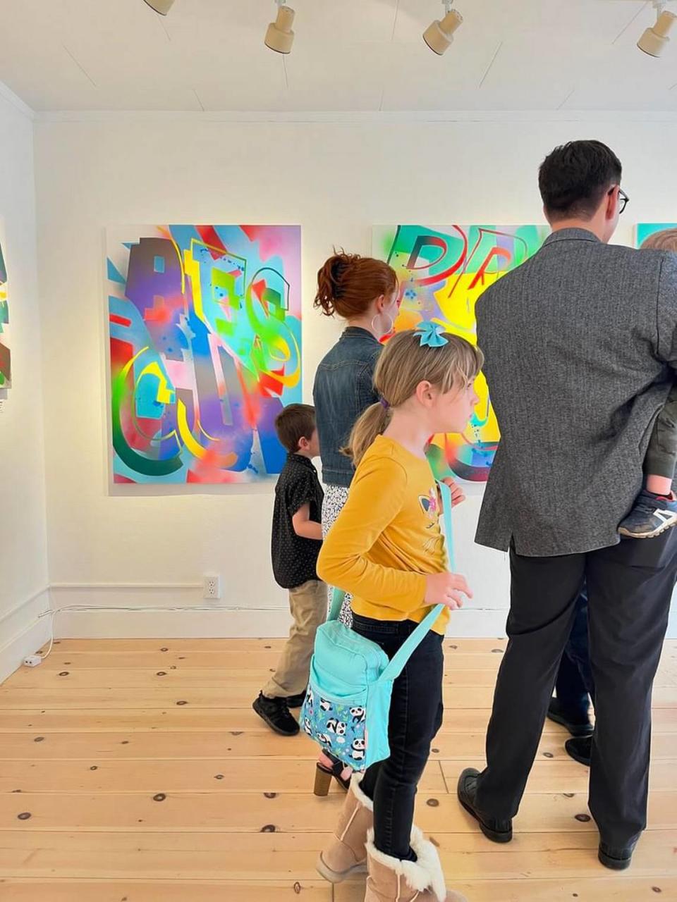 A family peruses the work of Tacoma artist Jared Michael Haviland in the Madsen Gallery in Los Altos, California.