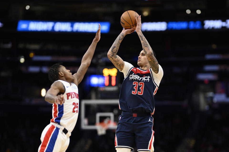 Washington Wizards forward Kyle Kuzma (33) looks to shoot against Detroit Pistons guard Marcus Sasser (25) during the second half of an NBA basketball game, Monday, Jan. 15, 2024, in Washington. (AP Photo/Nick Wass)