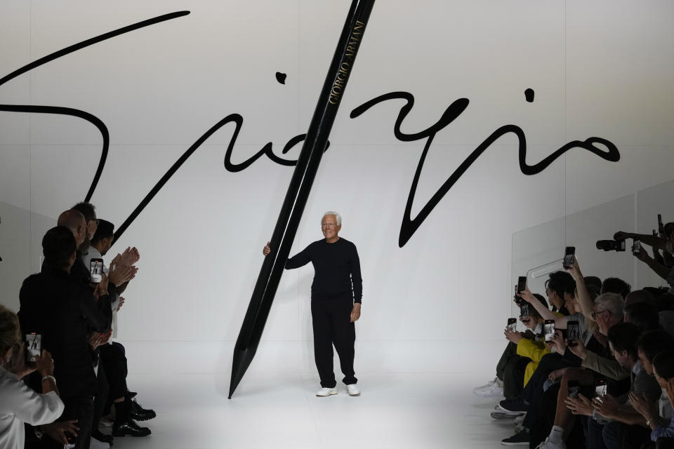 Designer Giorgio Armani receives applause at the end of the Giorgio Armani men's Spring Summer 2024 fashion show presented in Milan, Italy, Monday, June 19, 2023. (AP Photo/Luca Bruno)