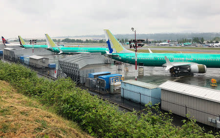 A row of three green 737 MAX jetliners sit parked on the tarmac at Renton Municipal Airport in Renton, Washington, U.S. May 16, 2019. REUTERS/Eric Johnson/Files