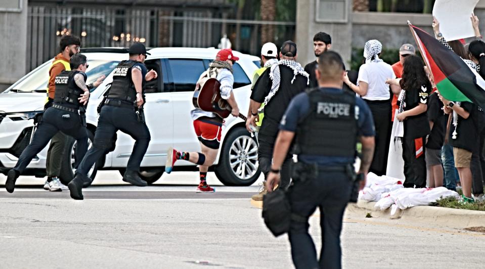 West Palm Beach Police chase Hawazin Gridley Wright, a teacher at Boynton Beach High School, after he strode into traffic during a pro-Palestinian rally on Nov. 19, 2023. Officers found a 10-inch knife under his shirt during his arrest.