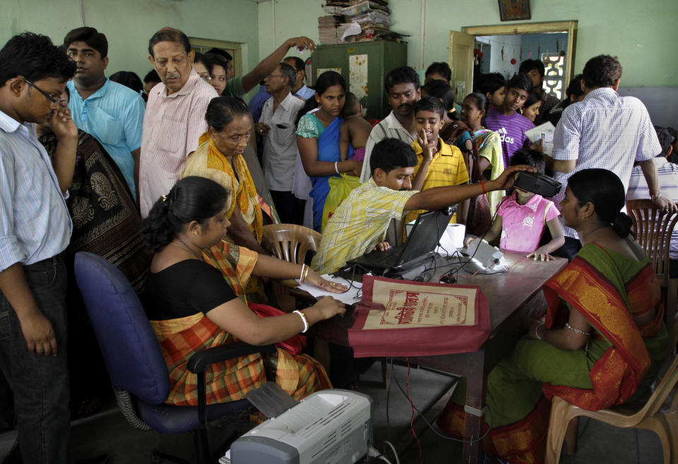 In this Wednesday, May 16, 2012, file photo, Indians crowd a room as they wait to enroll for Aadhar, India's unique identification project in Kolkata, India. A U.S.-based private cybersecurity company said Wednesday, Sept. 22, 2021, it has uncovered evidence that an Indian media conglomerate, a police department and the agency responsible for the country's national identification database have been hacked, likely by a state-sponsored Chinese group. (AP Photo/Bikas Das, File)