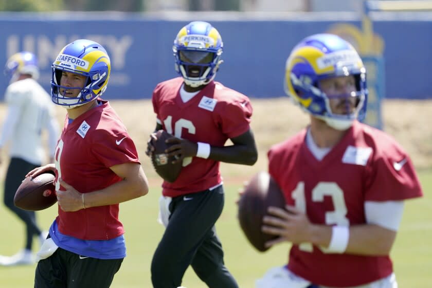 Los Angeles Rams quarterbacks Matthew Stafford, left, Bryce Perkins, center, and John Wolford.