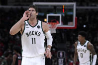 Milwaukee Bucks' Brook Lopez celebrates his 3-point basket during the first half of the team's NBA basketball game against the Chicago Bulls on Thursday, Feb. 16, 2023, in Chicago. (AP Photo/Charles Rex Arbogast)