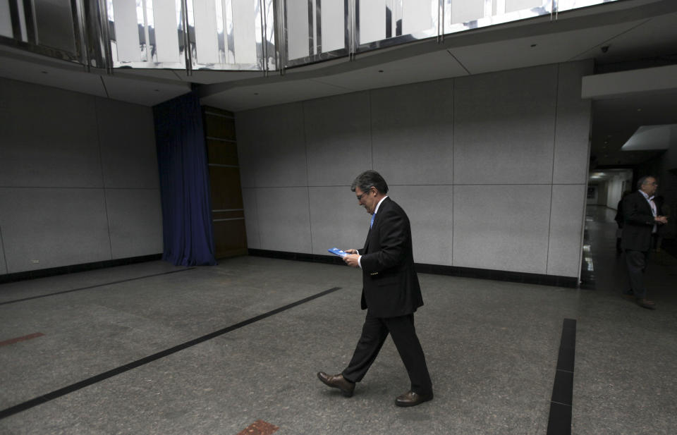 Marcel Granier, director of Radio Caracas Television Station (RCTV), leaves after a news conference with the foreign media at his office in Caracas, Venezuela, Tuesday, May 22, 2012. The opposition-aligned TV channel, which was forced off the air nearly five years ago by the Venezuelan government, used to employ thousands but now very few roam the studios. RCTV transmits via cable TV outside Venezuela. (AP Photo/Fernando Llano)