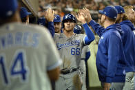 Kansas City Royals' Ryan O'Hearn, center, is congratulated by teammates after scoring a run on a sacrifice fly from Whit Merrifield in the third inning of a baseball game against the Detroit Tigers, Friday, Sept. 24, 2021, in Detroit. (AP Photo/Jose Juarez)