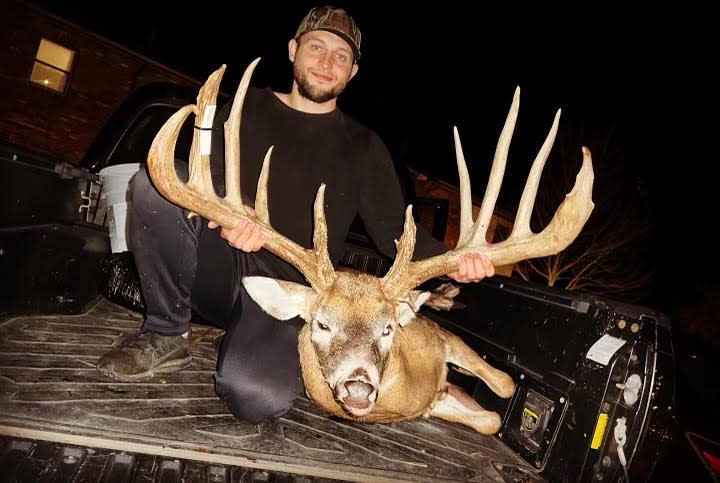 Hunter Christopher "CJ" Alexander poses with the deer he killed. The deer's rack was green-scored at a typical 206 7/8 inches, which would push it 5 inches past the Ohio record.