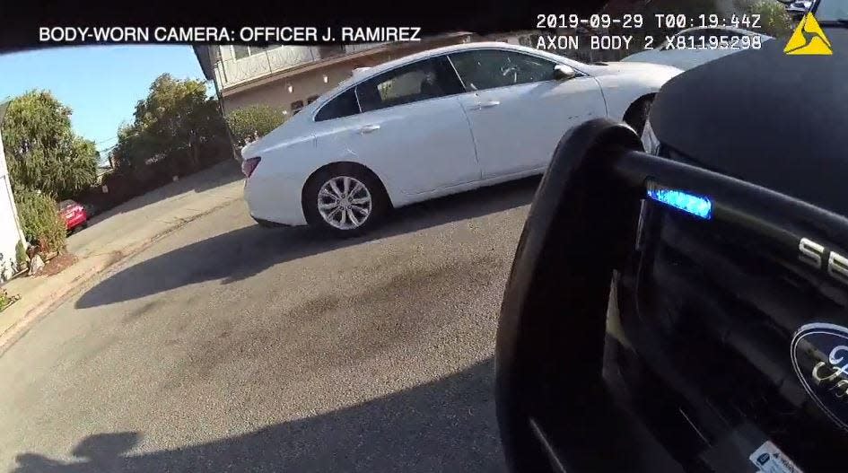 A San Mateo, California, police officer fires his gun at a car with two women - one from Delaware - who investigators said went on a 48-hour crime spree in that state.