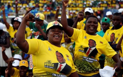 Crowds cheer at an election rally of President Emmerson Mnangagwa's ruling ZANU PF party in Mutare - Credit: Philimon Bulawayo/Reuters