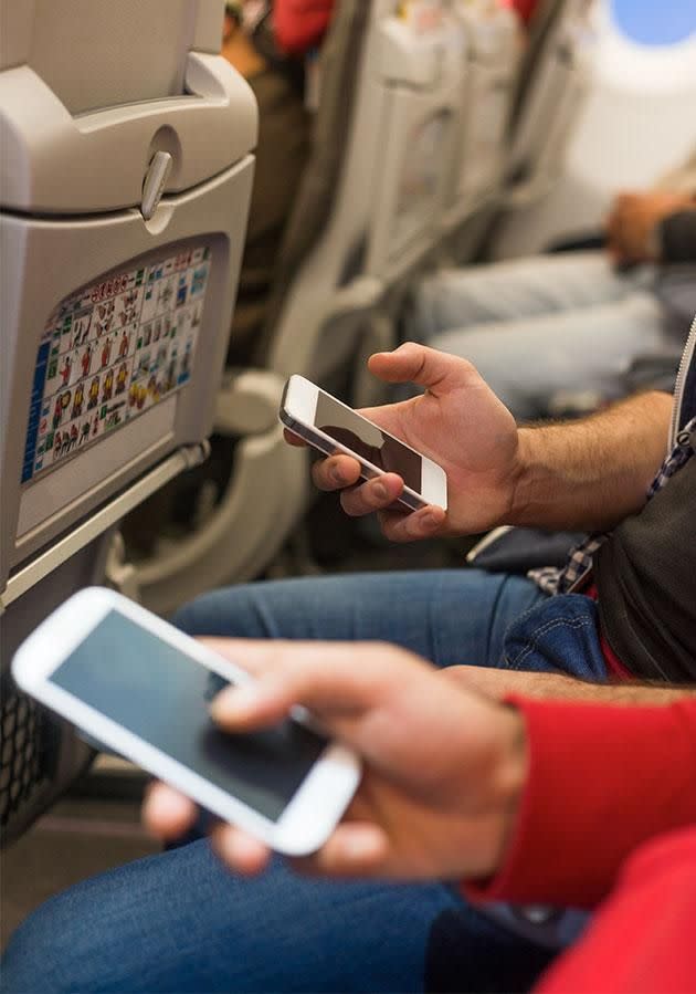 Leaving your phone on mid-flight can drain its battery. Photo: Getty Images