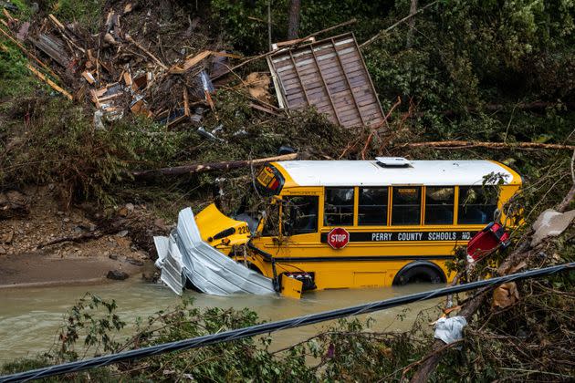 A Perry County school bus, along with other debris, sits in a creek near Jackson, Kentucky, on July 31. (Photo: SETH HERALD/AFP/Getty Images)