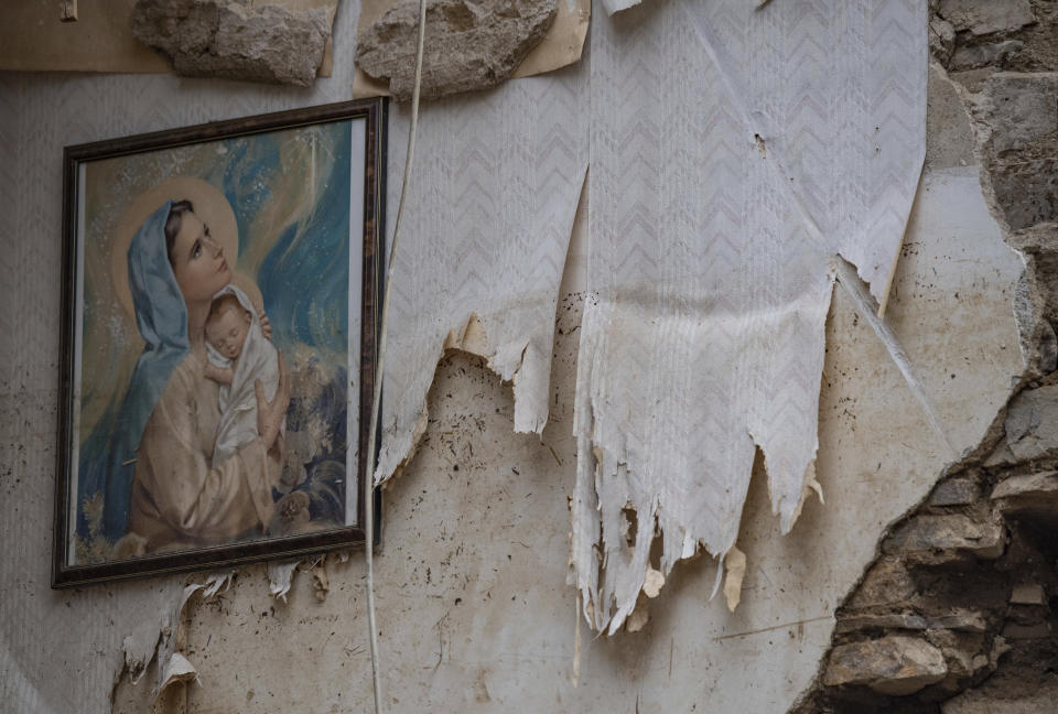 A picture of St Mary hangs in the attic of a house in Altenahr, Germany, Monday, July 19, 2021. Numerous houses in the town were completely destroyed or severely damaged, there are numerous fatalities. (Boris Roessler/dpa via AP)