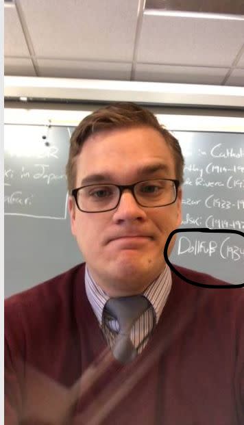 White nationalist teacher Benjamin Welton in a since-deleted photo from the Faculty section of Star Academy's website. On the chalkboard behind him is the name of an Austrian fascist (circled). (Photo: HuffPost)