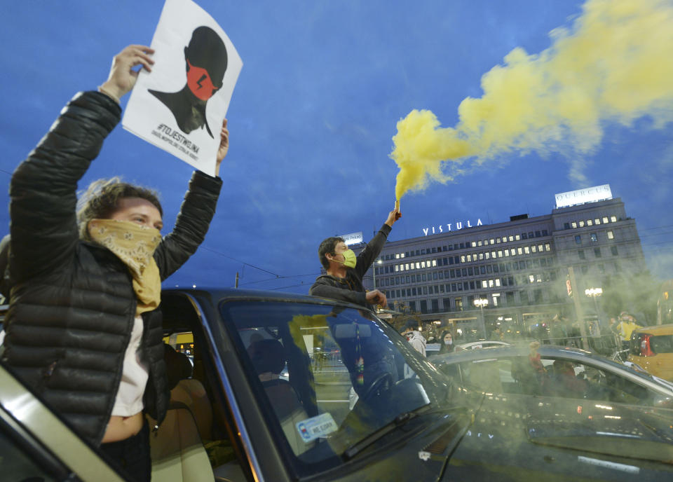 Angered women's rights activists and their supporters block rush-hour traffic at a major roundabout on the fifth day of nationwide protests against recent court ruling that tightened further Poland's restrictive abortion law, in Warsaw, Poland, on Monday, Oct. 26, 2020. The court effectively banned almost all abortions. (AP Photo/Czarek Sokolowski)