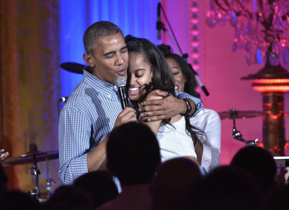 4 July 2016: US President Barack Obama hugs his daughter Malia on her birthday during an Independence Day Celebration for military members and administration staff in the White House (Mandel Ngan/AFP/Getty Images)