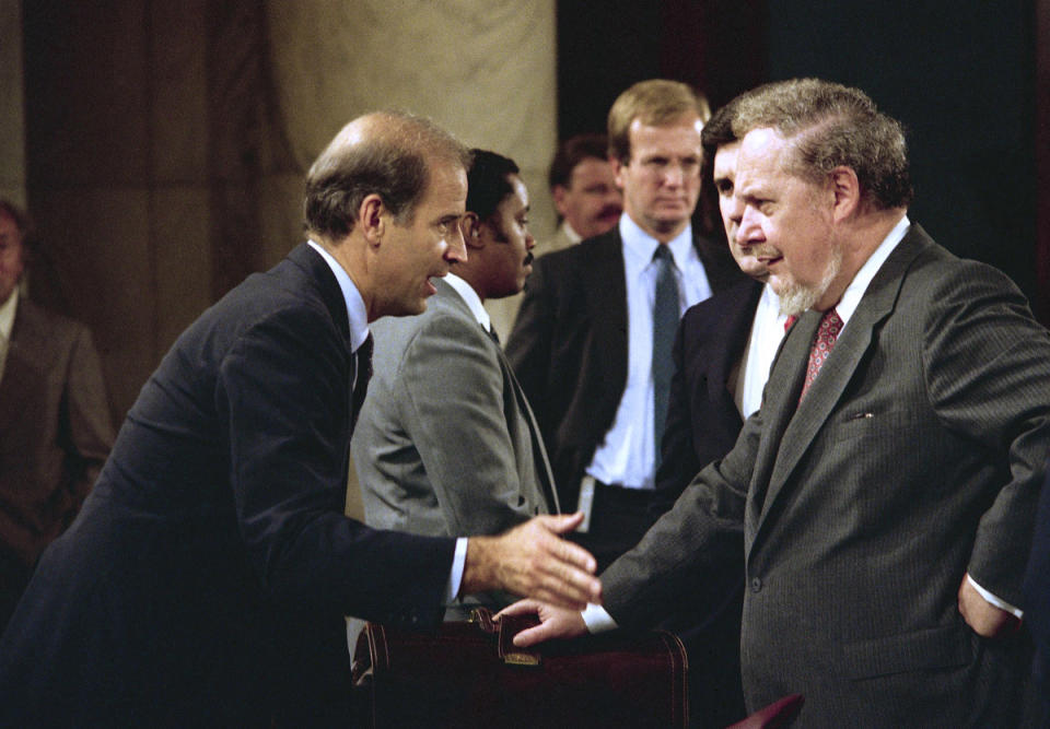 Biden greets Judge Robert Bork prior to a hearing of the Senate Judiciary Committee on Bork's Supreme Court nomination, Sept. 17, 1987.