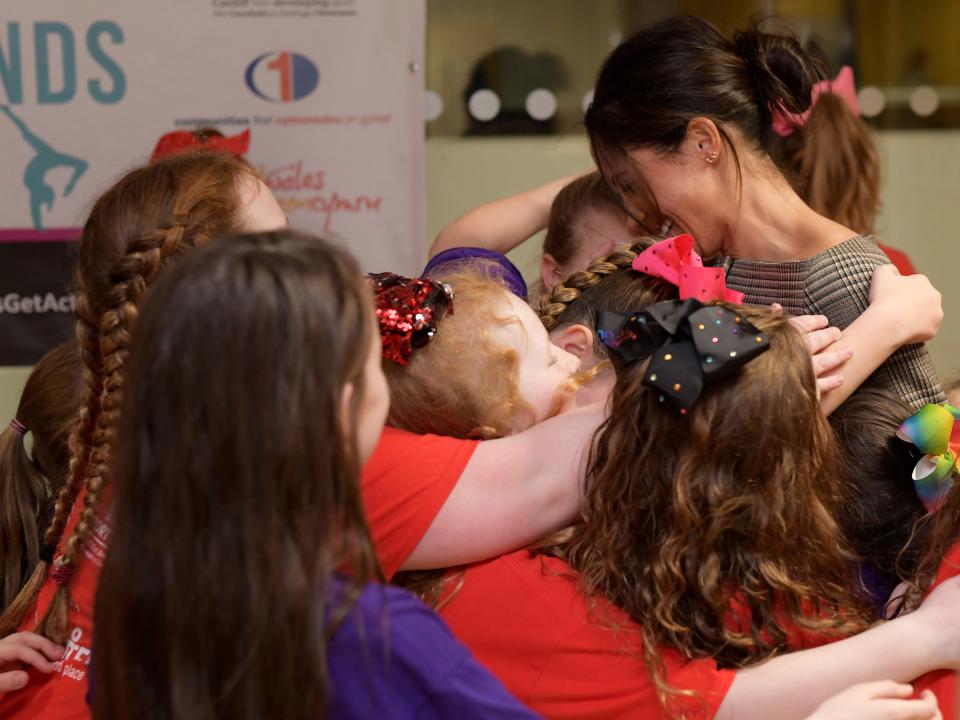 Meghan Markle is hugged by a group of young girls