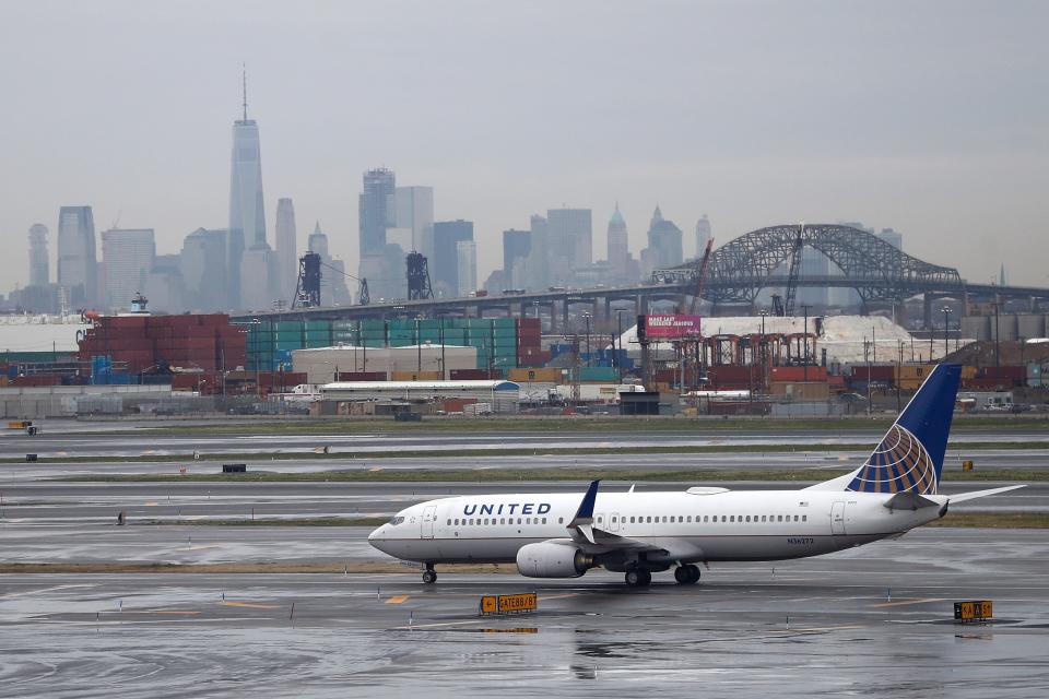 The New York City skyline gives backdrop to a United Airlines airplane taxing at Newark Liberty International Airport, Wednesday, April 12, 2017, in Newark, N.J. (AP Photo/Julio Cortez) ORG XMIT: NJJC10