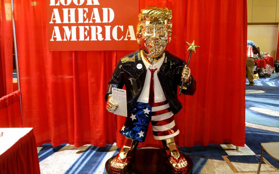 A Trump supporter sculpted a gold statue of the former president that was on display at the conference - REUTERS