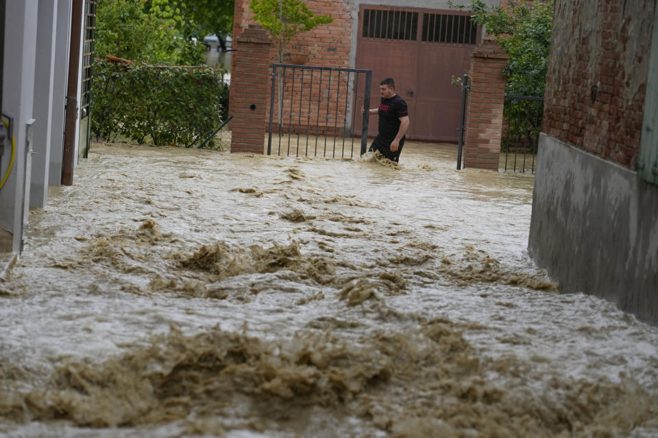 Muddy water rages through a flooded street in the village of Castel Bolognese, Italy, Wednesday, May 17, 2023. Exceptional rains Wednesday in a drought-struck region of northern Italy swelled rivers over their banks, killing at least eight people, forcing the evacuation of thousands and prompting officials to warn that Italy needs a national plan to combat climate change-induced flooding. (AP Photo/Luca Bruno)